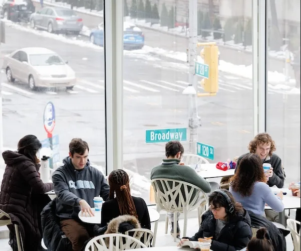 Columbia students having coffee and talking between classes on campus.