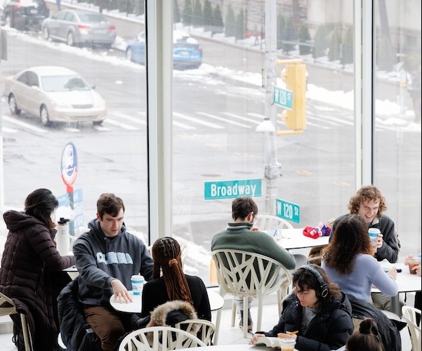 Columbia students having coffee and talking between classes on campus.